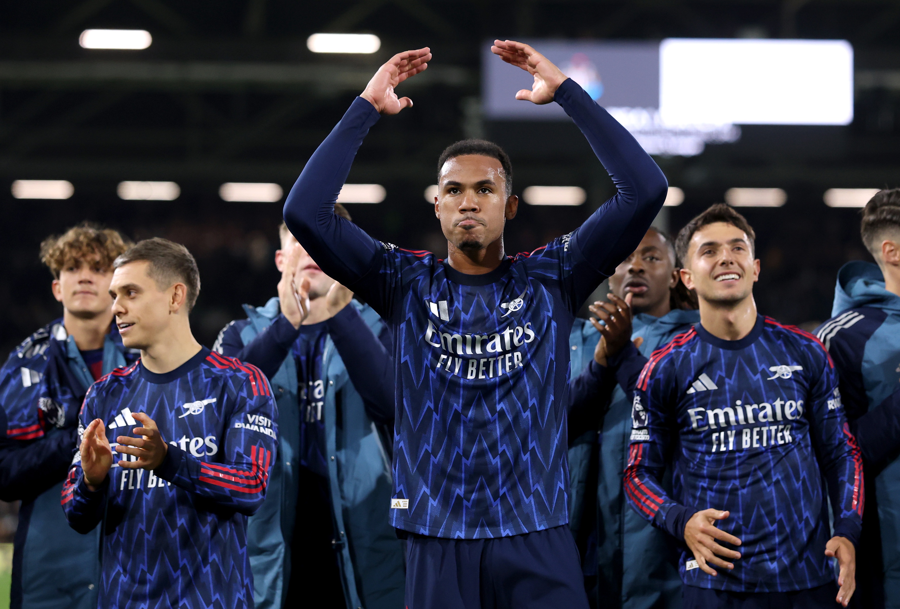 Arsenal defender Gabriel throws up his arms in celebration.