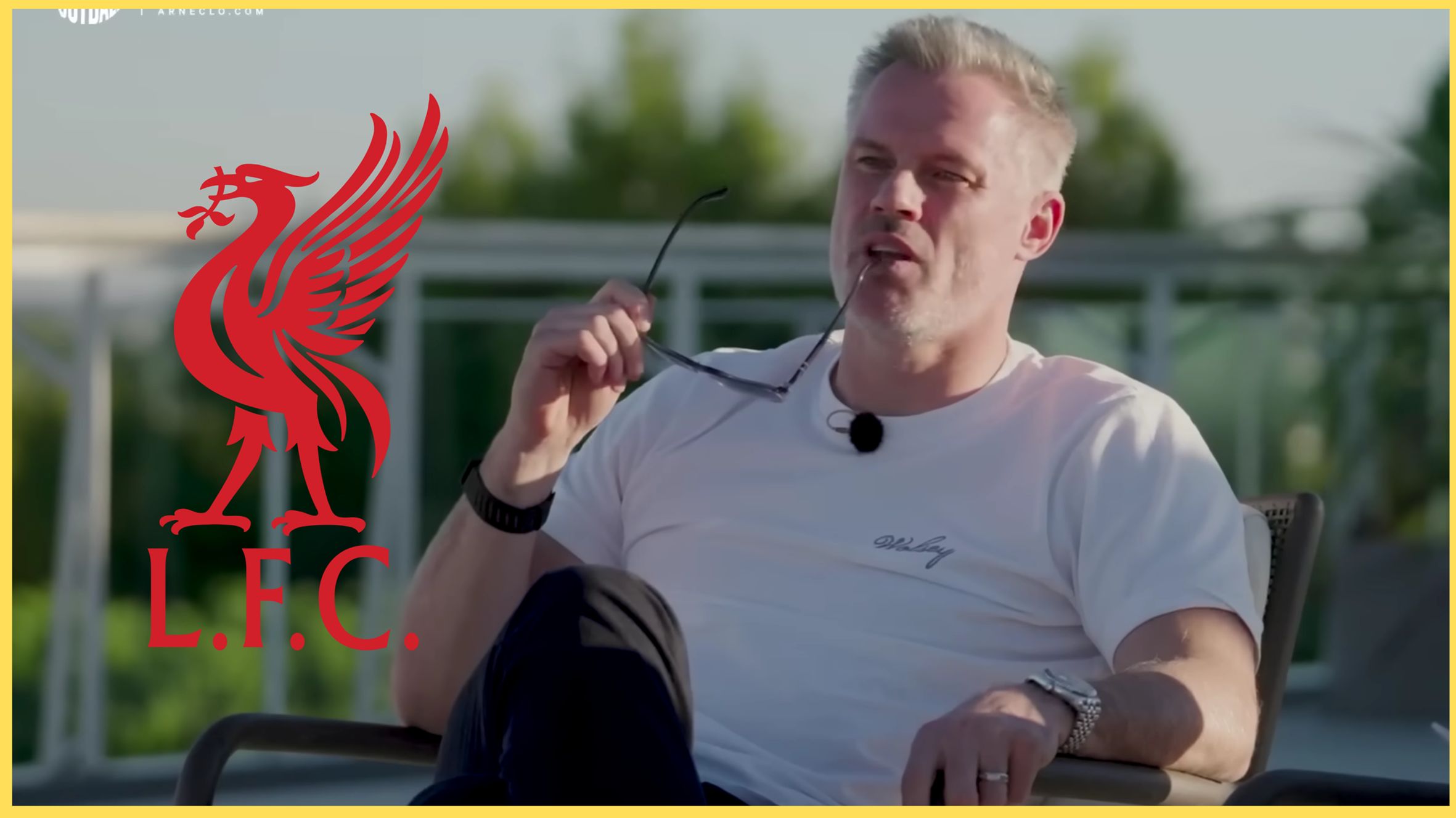Jamie Carragher chews his glasses next to the Liverpool club crest.