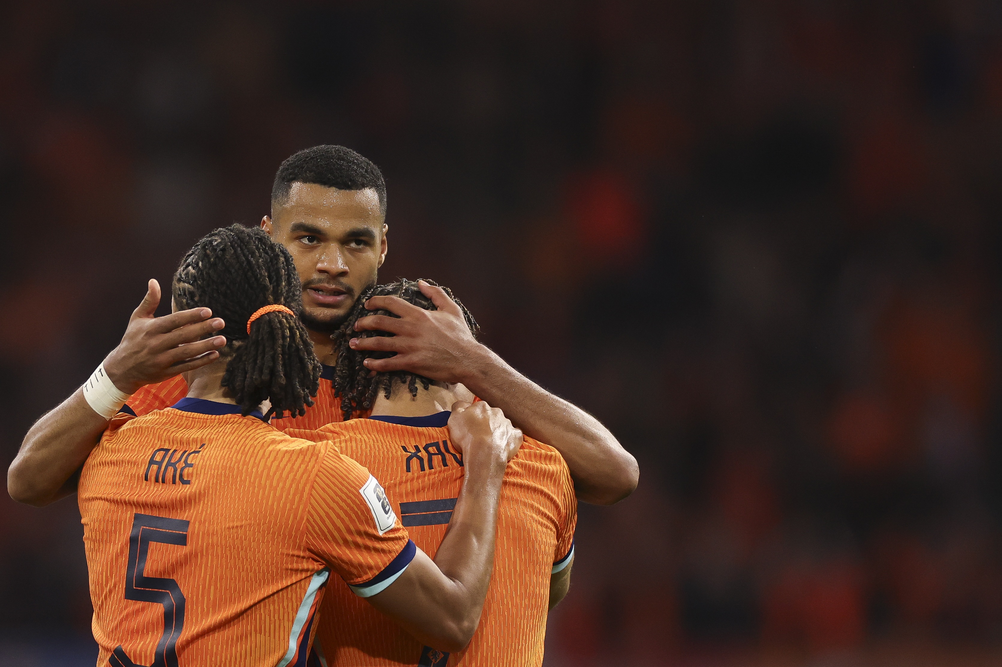 Cody Gakpo hugs Nathan Ake and Xavi Simons during Netherlands game.