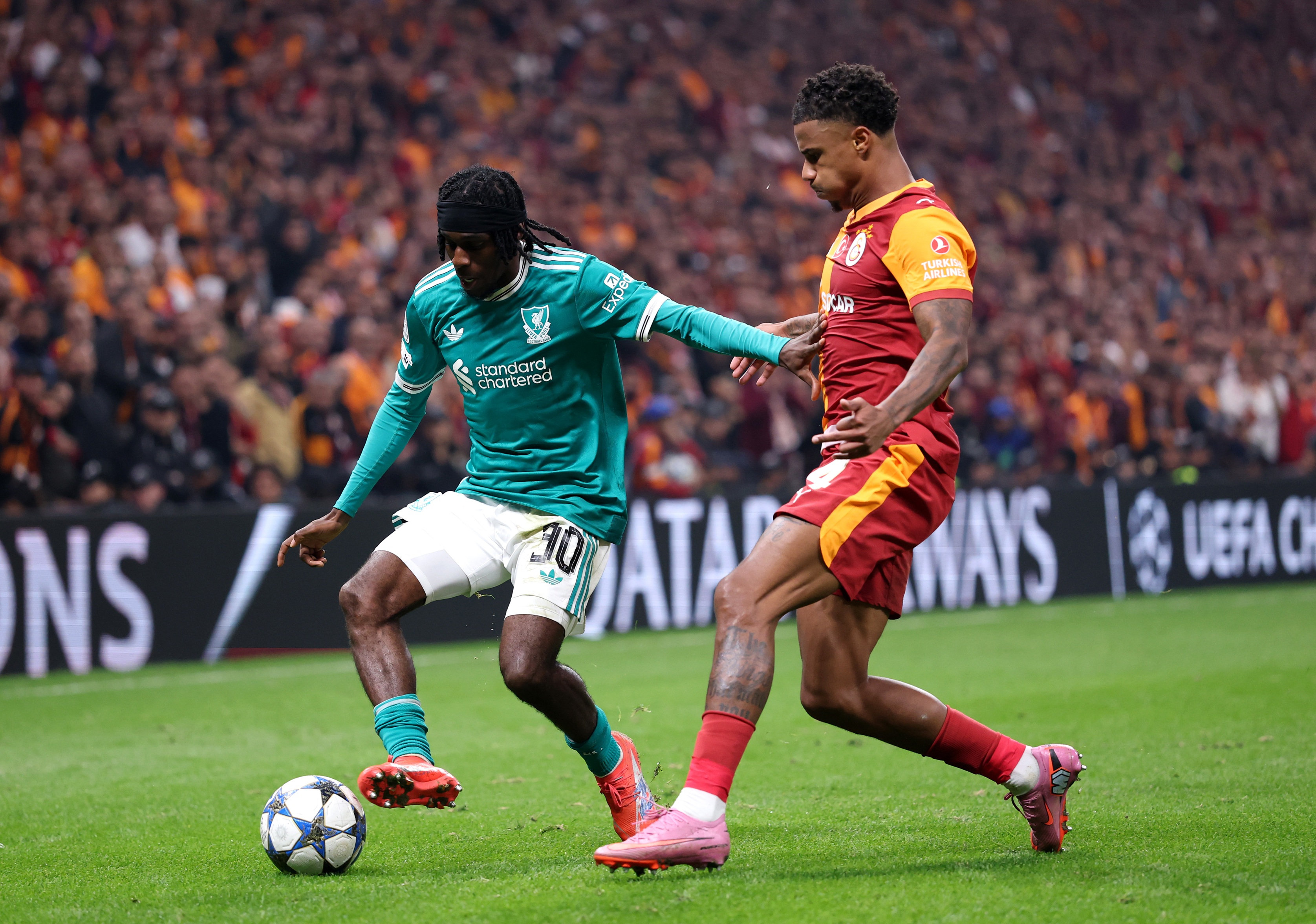 Jeremy Frimpong stops Ismail Jakobs as he controls the ball.