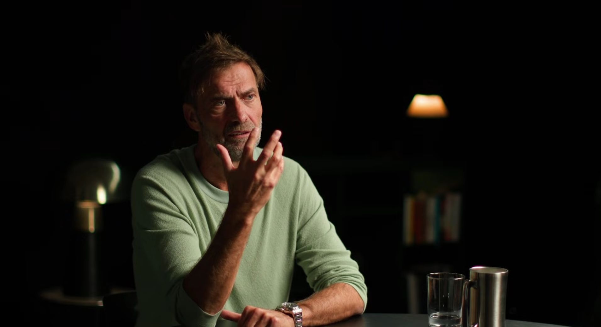Jurgen Klopp gestures with one hand in a sit down interview.