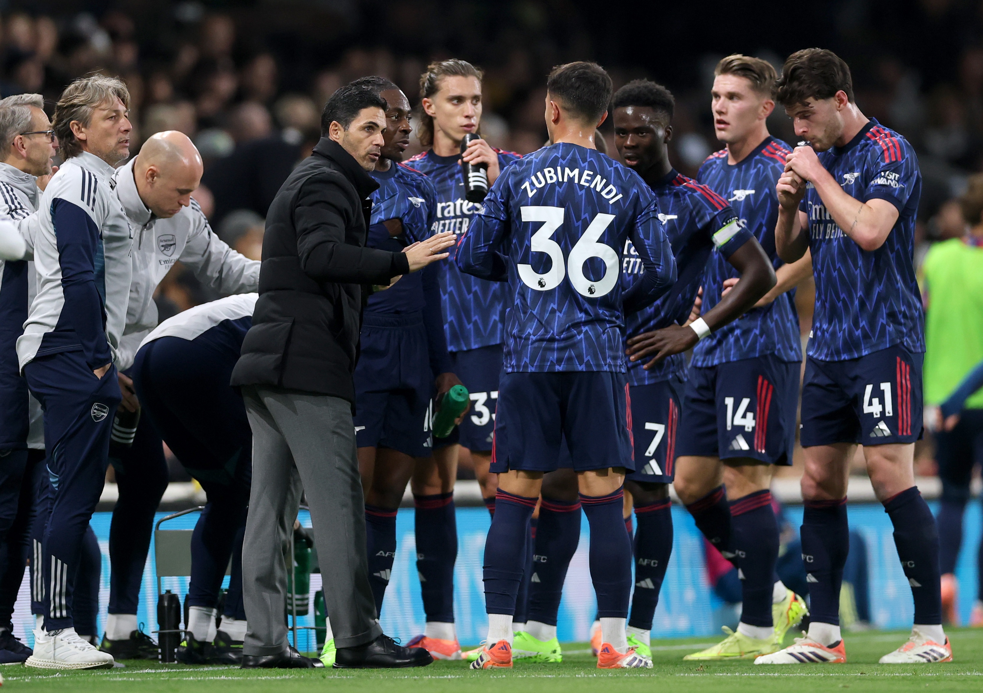 Mikel Arteta speaks to his Arsenal players on the touchline.