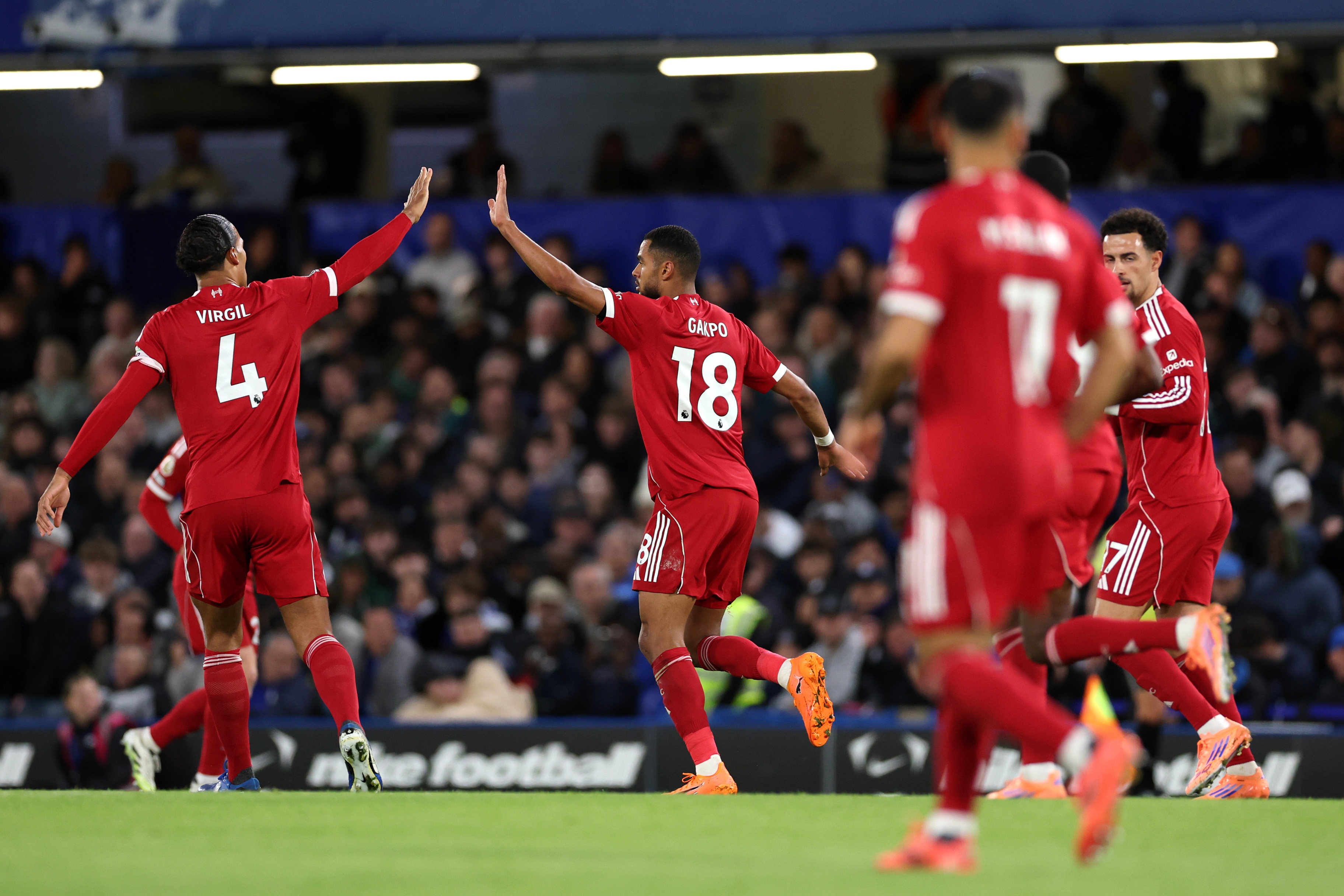 Virgil van Dijk high fives Cody Gakpo during Liverpool game.