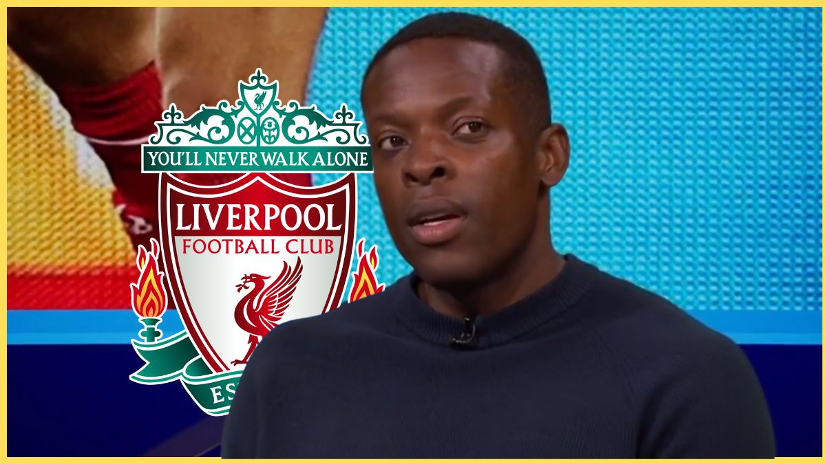 Nedum Onuoha speaks in front of screen with Liverpool club crest in background.