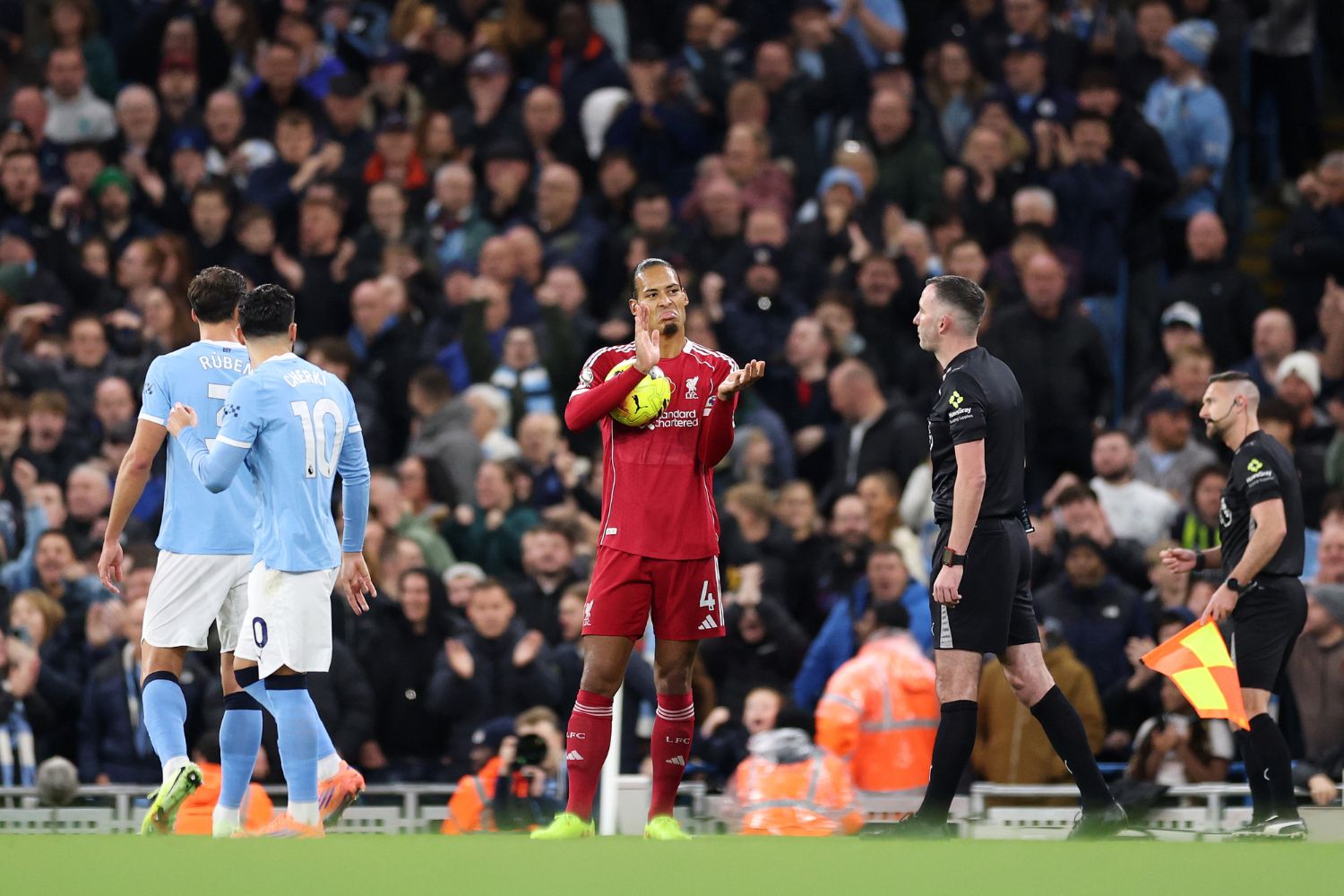 Virgil van Dijk of Liverpool reacts towards Referee Chris Kavanagh