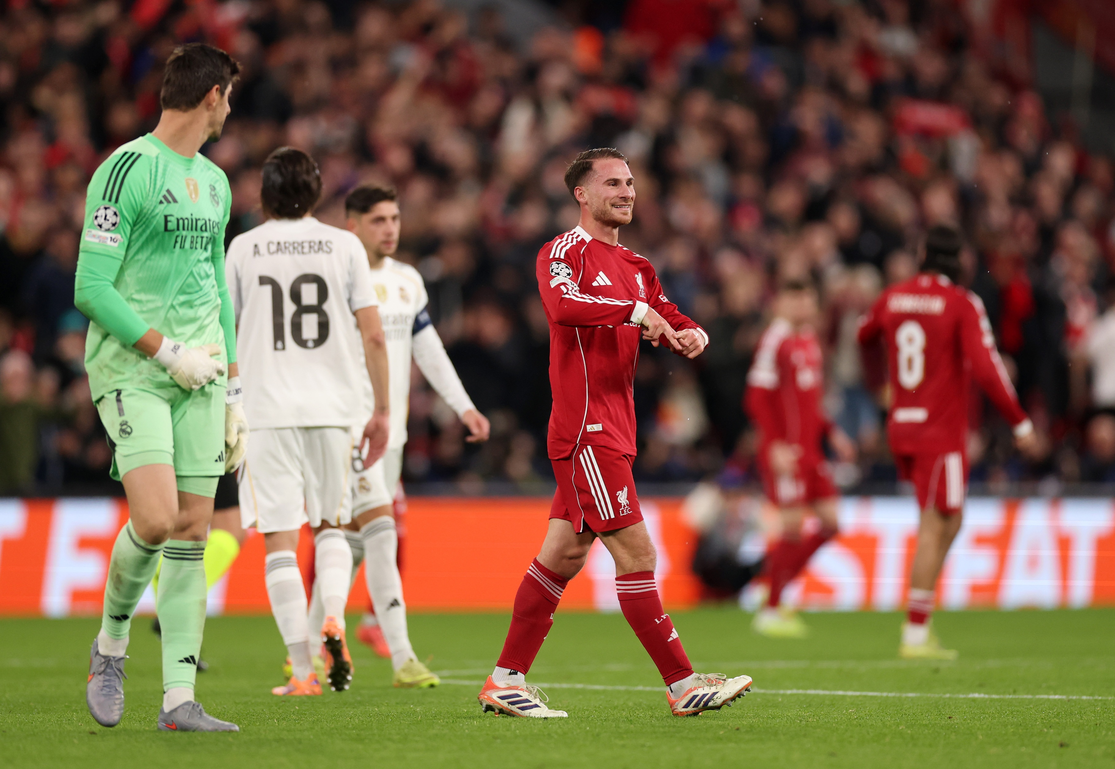 Alexis Mac Allister makes hand gesture when celebrating Liverpool goal.