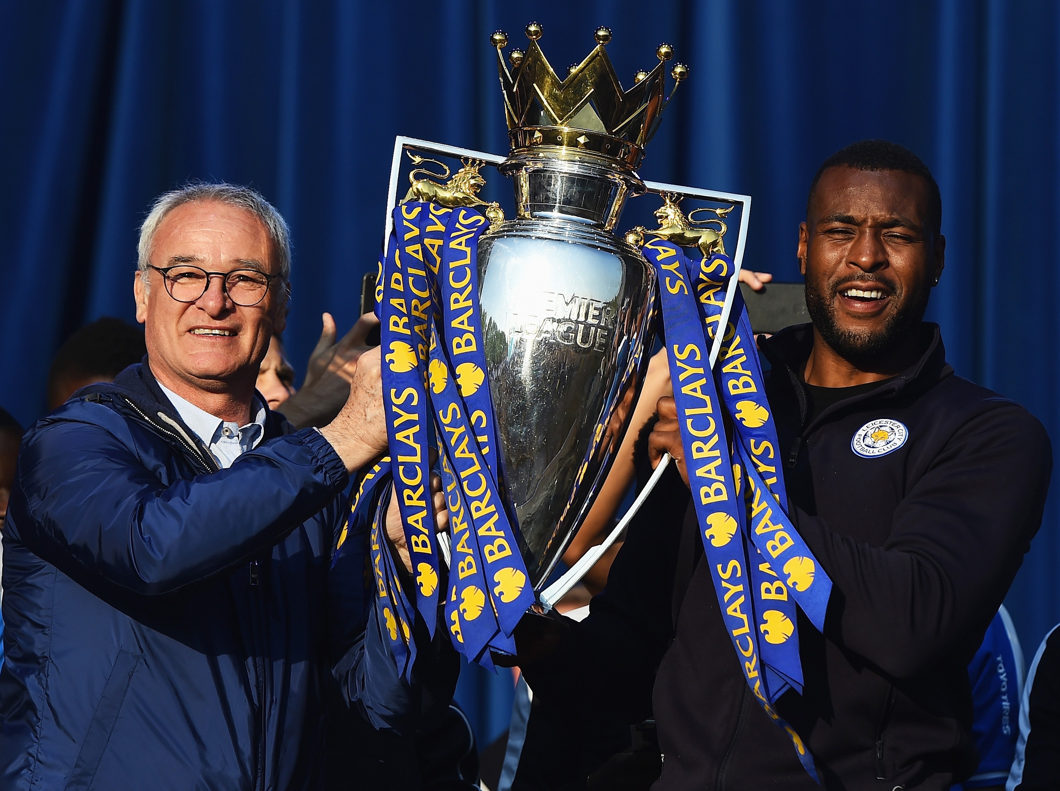 Claudio Ranieri lifts the Premier League trophy with Wes Morgon.