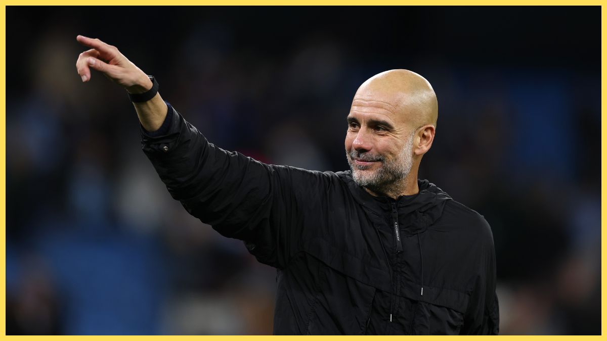 Pep Guardiola, Manager of Manchester City, acknowledges the fans