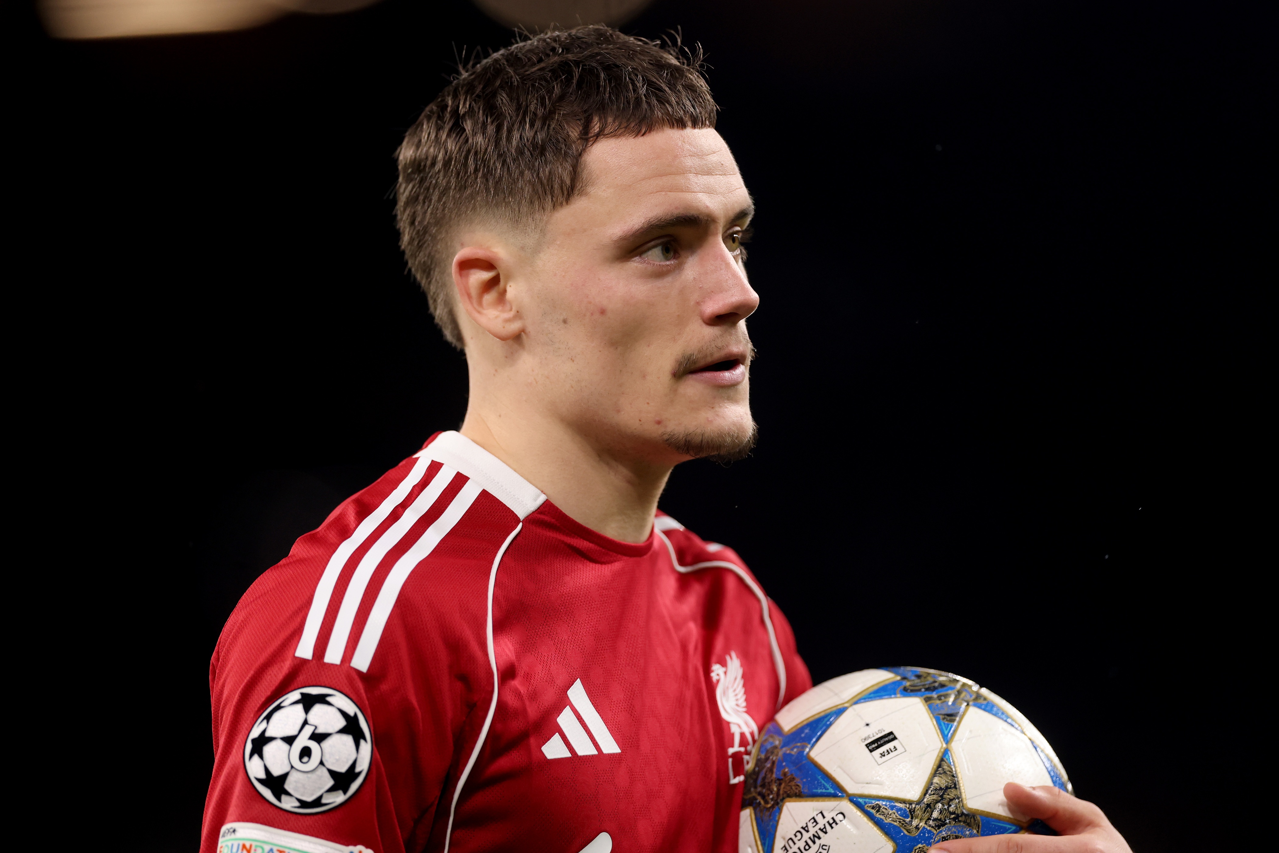 Florian Wirtz holds a football during Champions League game.