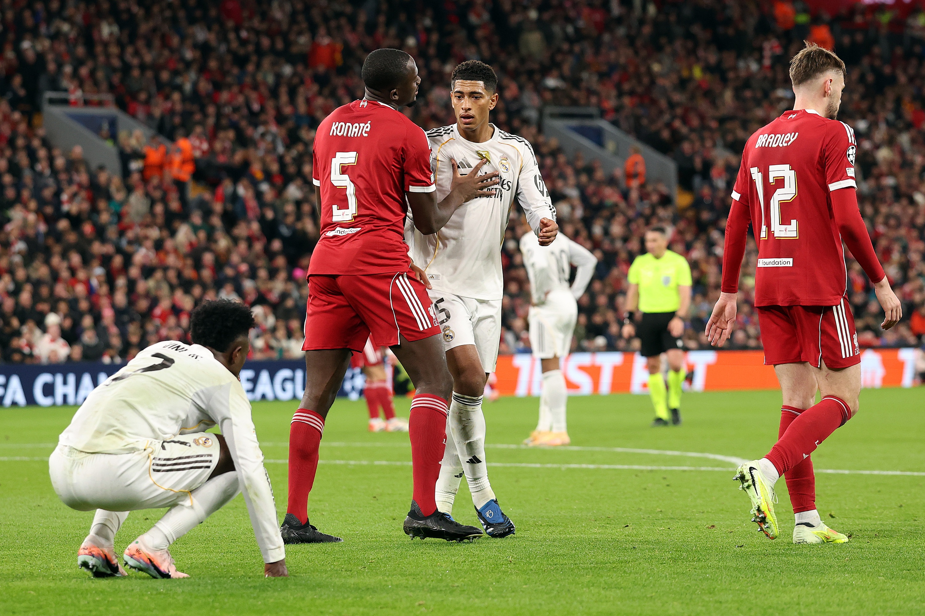 Ibrahima Konate pushes Jude Bellingham back.