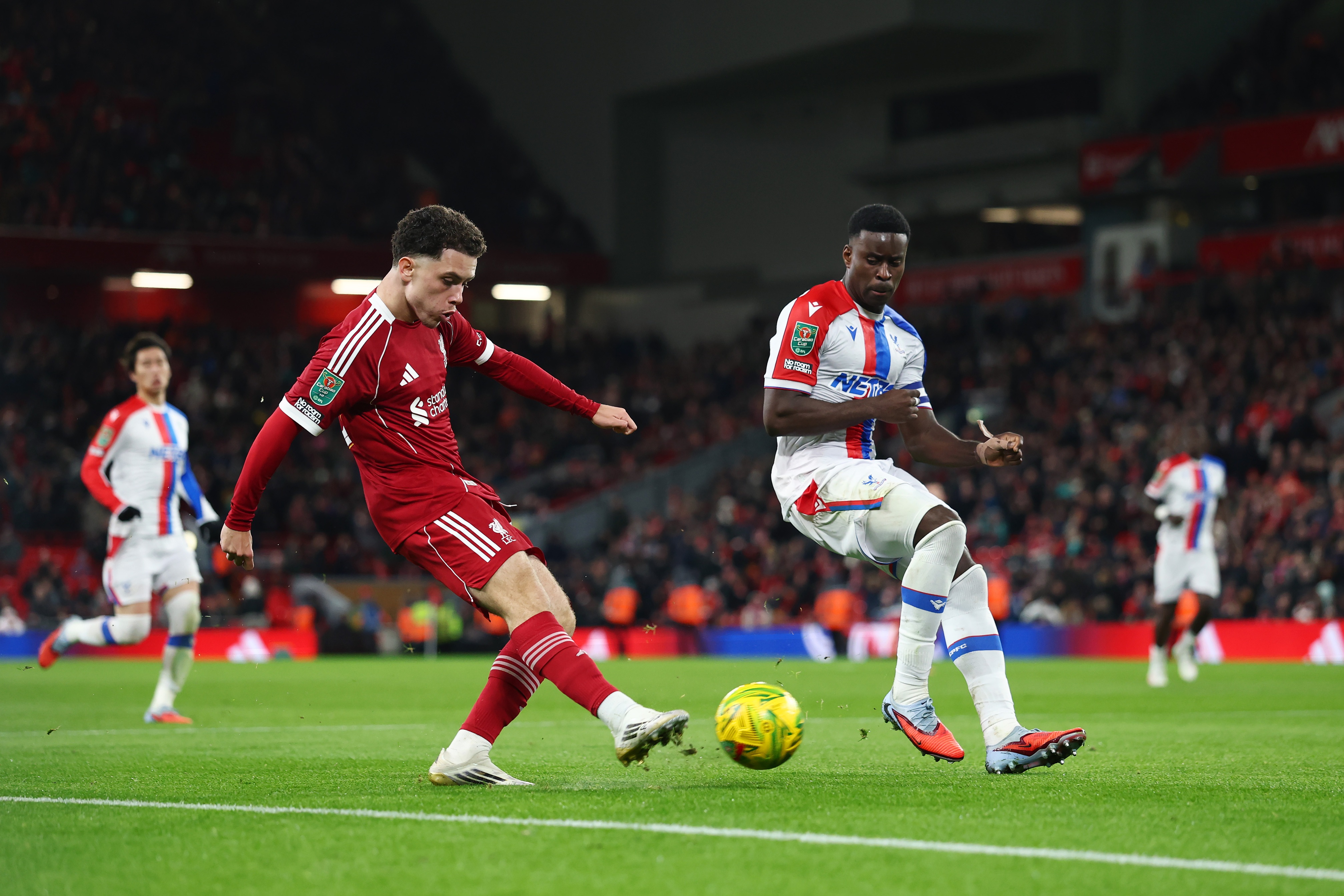 Marc Guehi puts pressure on Liverpool player Kieran Morrison.