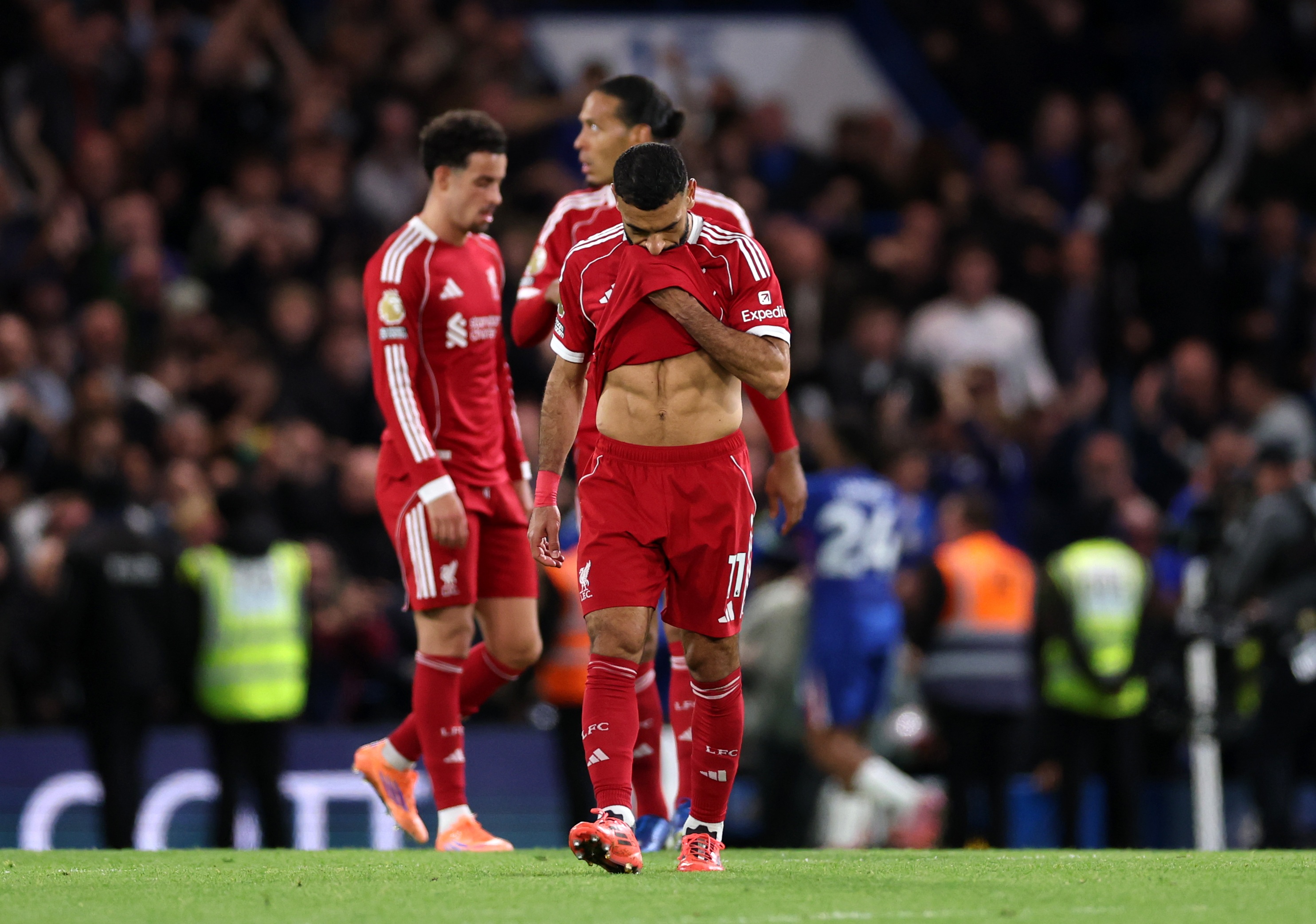 A distraught Mo Salah wipes his face with his Liverpool shirt.