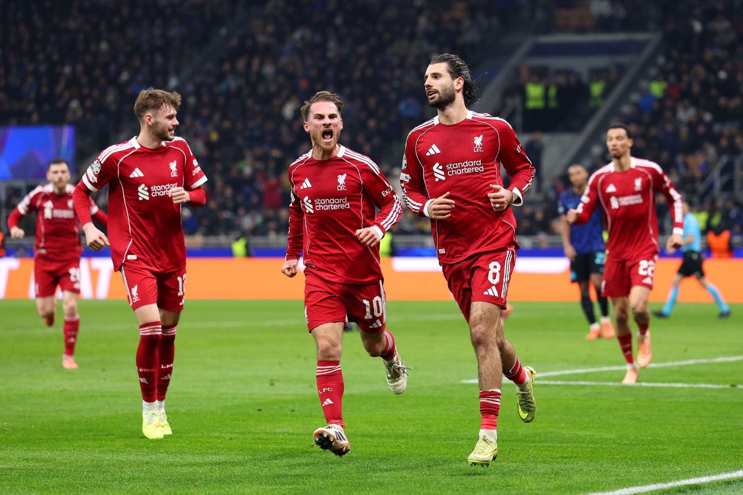 Liverpool players celebrate after Dominik Szoboszlai's winning penalty in Milan