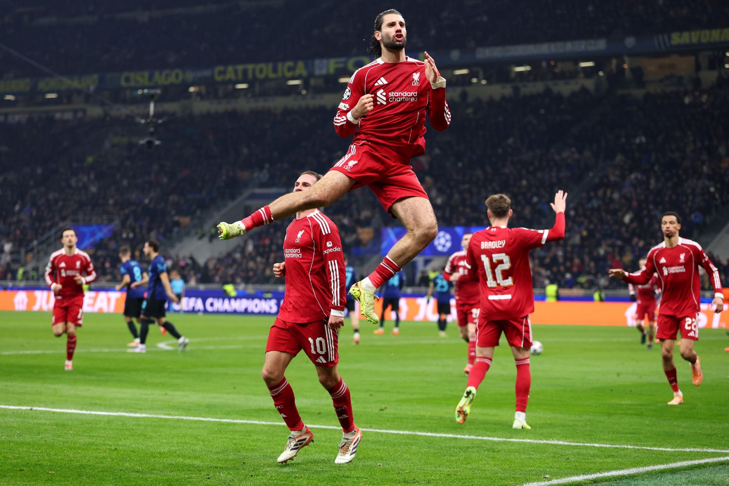 Liverpool players celebrate after Dominik Szoboszlai's winning penalty in Milan