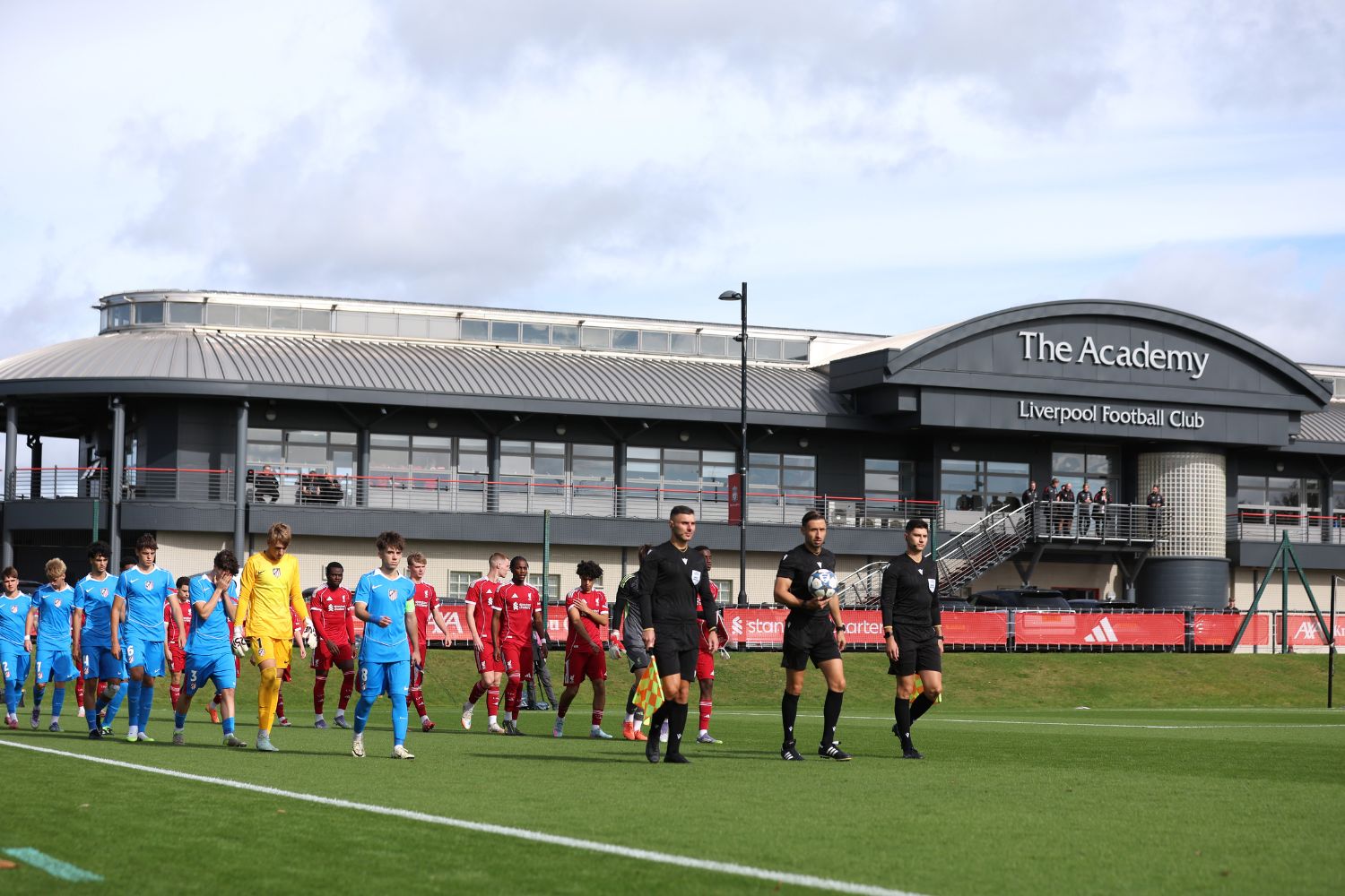 Liverpool and Atletico de Madrid walk out onto the pitch prior to the UEFA Youth League match