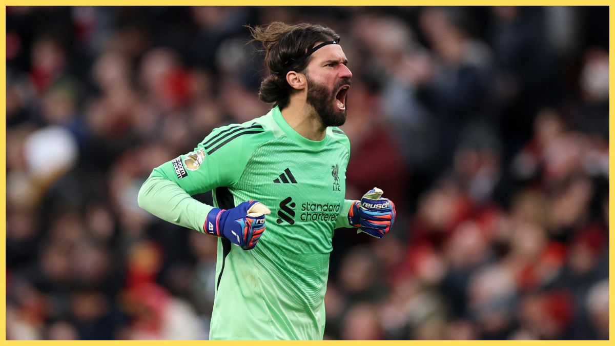 Alisson Becker celebrates to the Kop against Wolves
