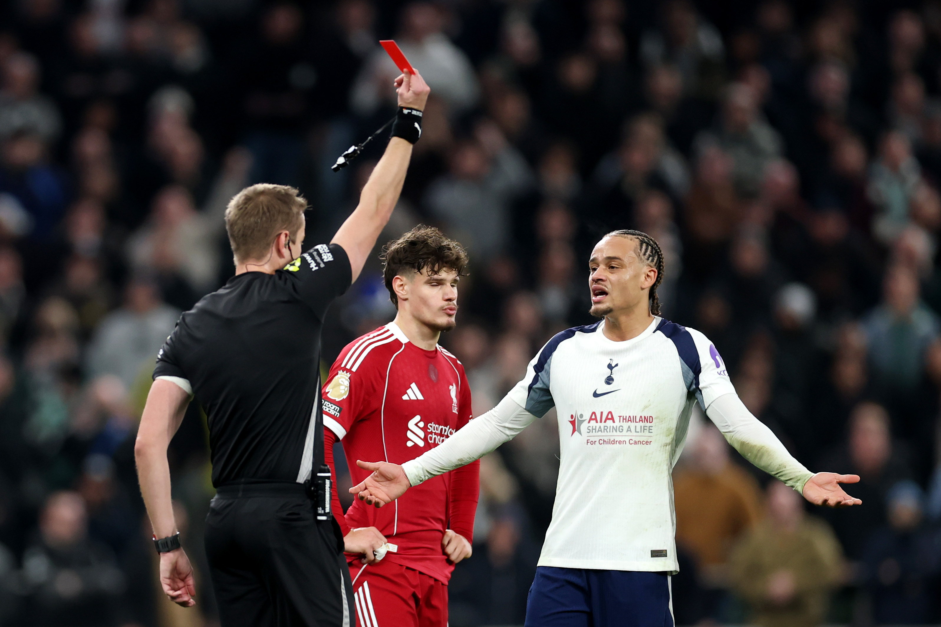 Xavi Simons protests at receiving a red card against Liverpool