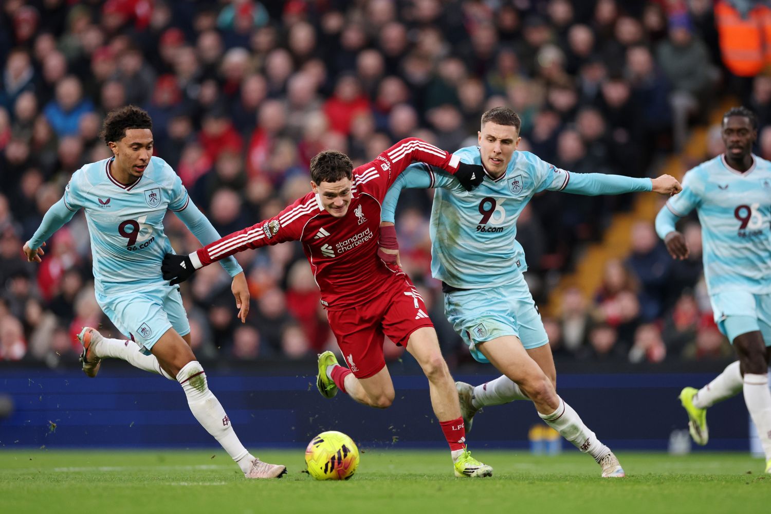 Florian Wirtz of Liverpool is challenged by Bashir Humphreys and Maxime Esteve of Burnley