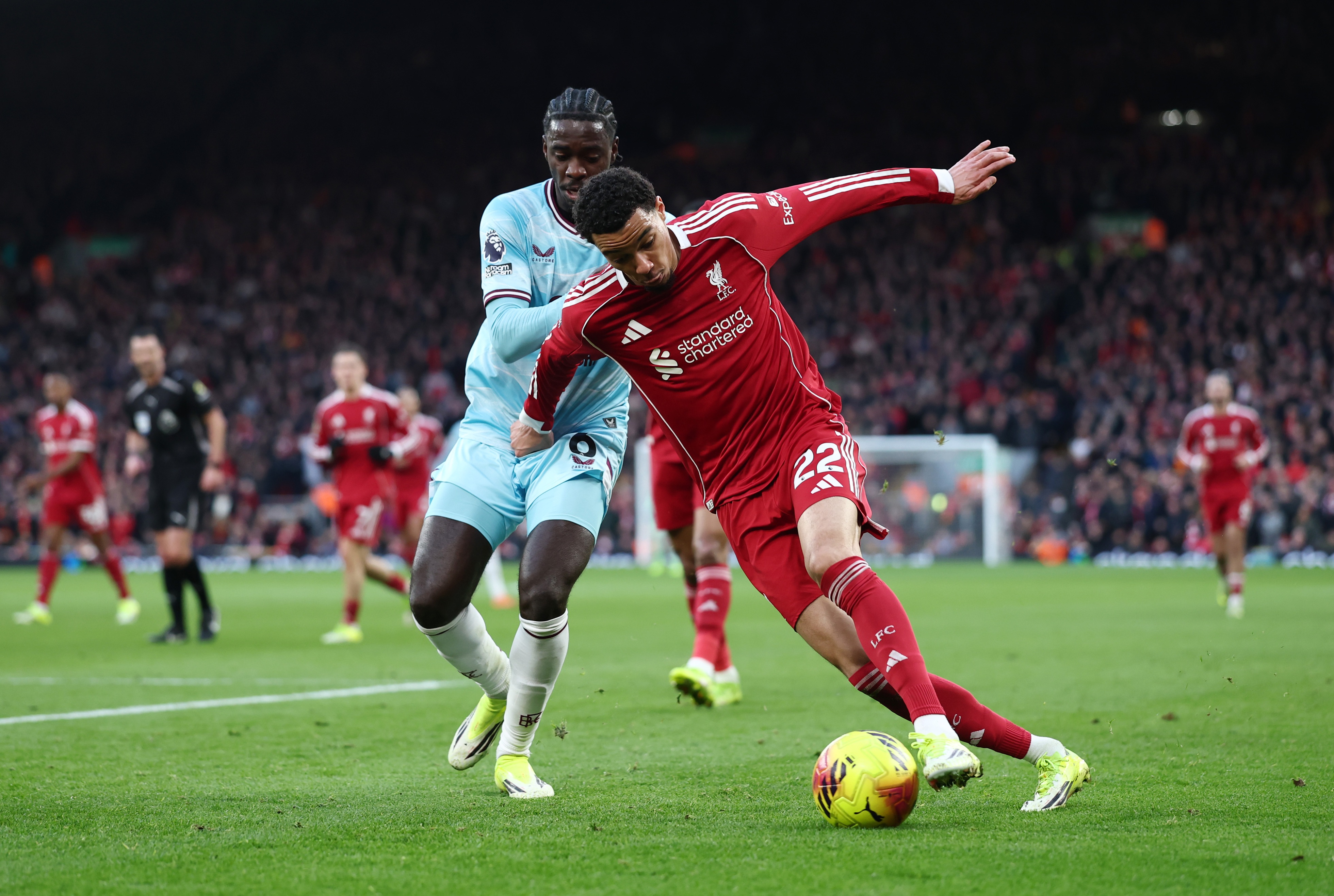 Hugo Ekitike dribbles past Axel Tuanzebe.