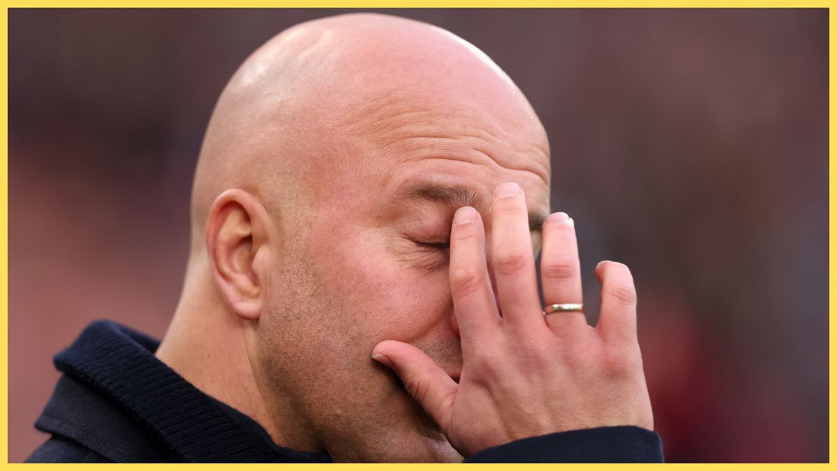 Arne Slot scratches his face.