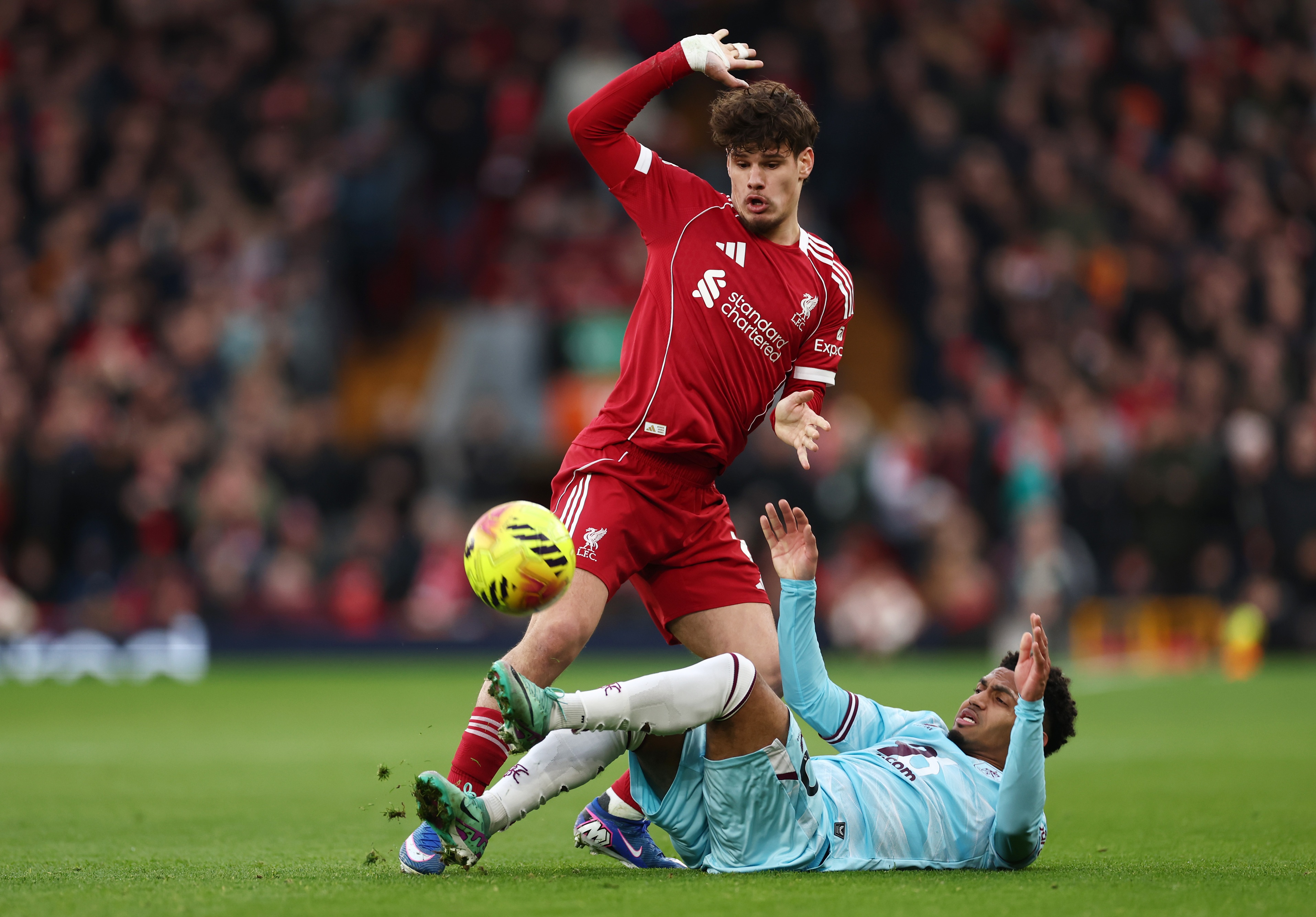 Milos Kerkez stands over Marcus Edwards during battle for the ball.