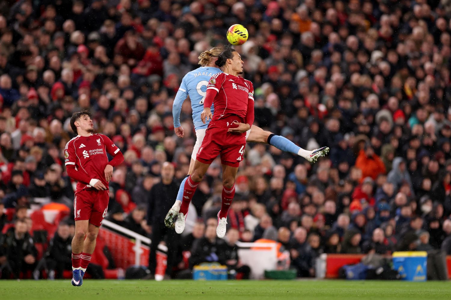 Virgil van Dijk of Liverpool contends for the aerial ball with Erling Haaland of Manchester City during the Premier League match between Liverpool and Manchester City