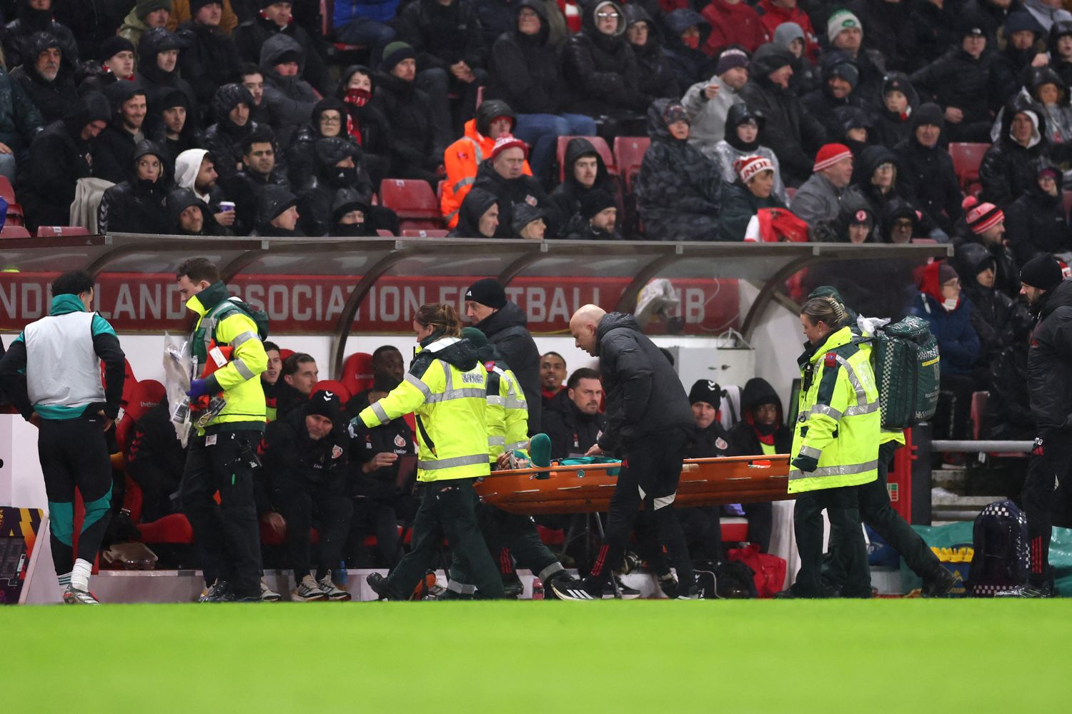 Wataru Endo of Liverpool is stretched off the pitch against Sunderland