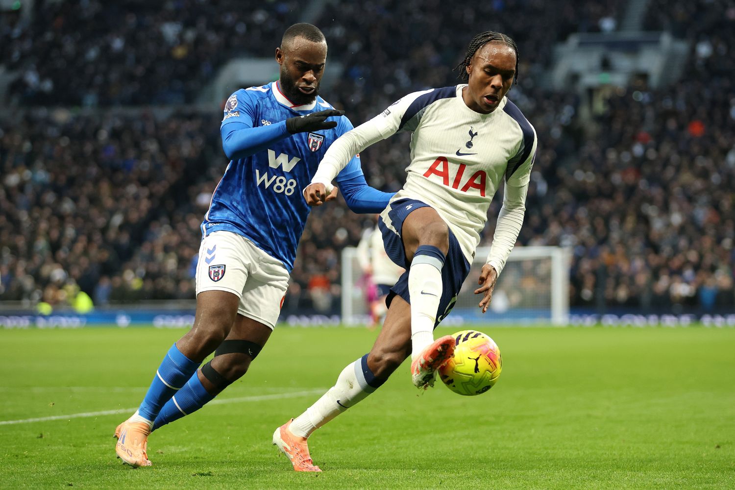 Mathys Tel of Tottenham Hotspur is challenged by Lutsharel Geertruida of Sunderland