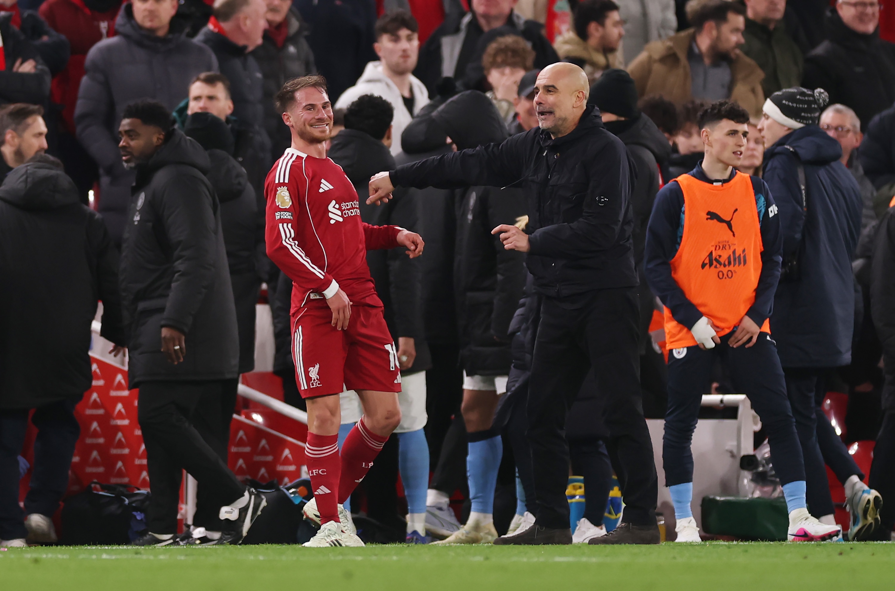 Alexis Mac Allister smiles next to an animated Pep Guardiola.
