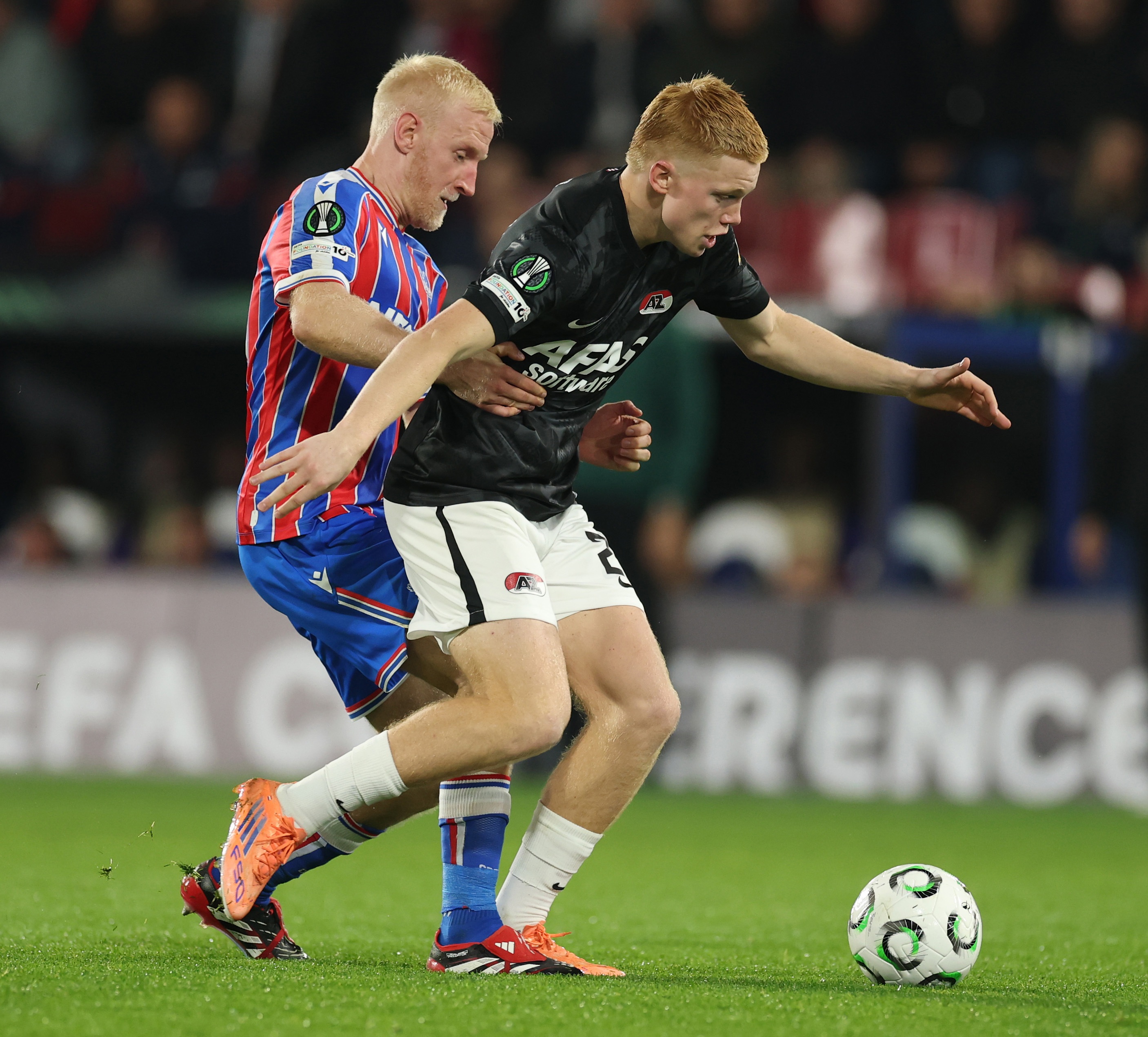 Crystal Palace's Will Hughes grabs Kees Smit by the waist.