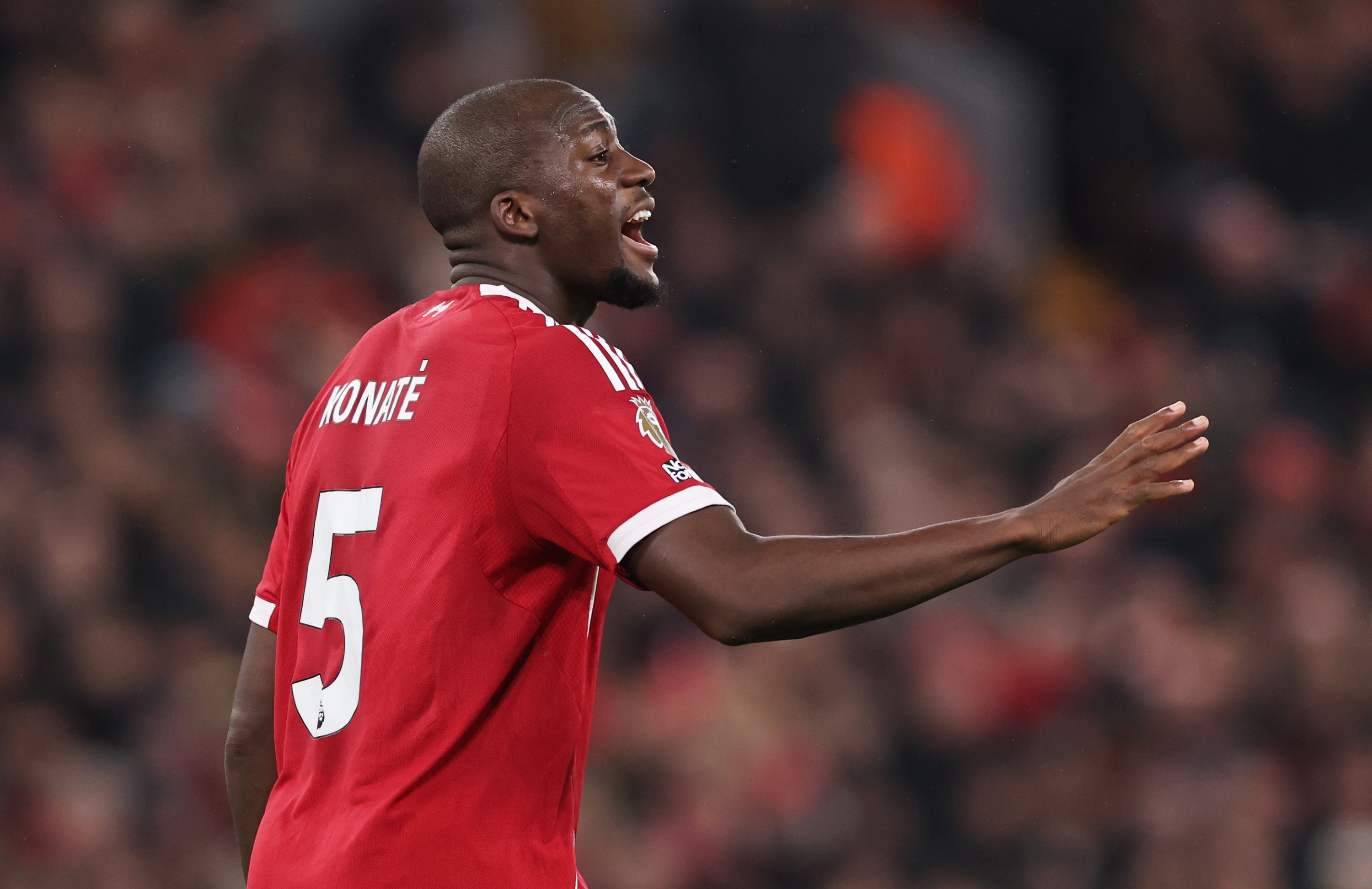 Ibrahima Konate shouts and raises his right arm.