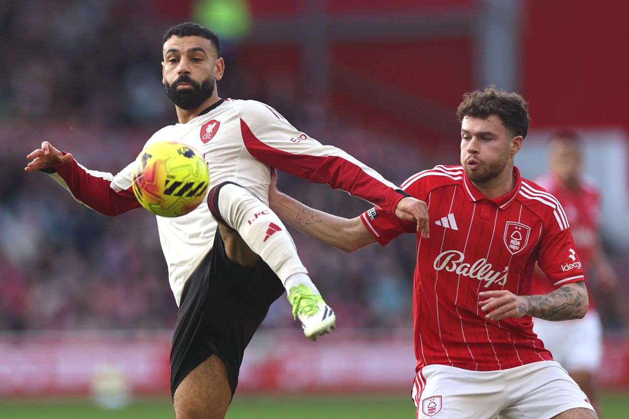 Mo Salah controls the ball in mid-air during Liverpool game.