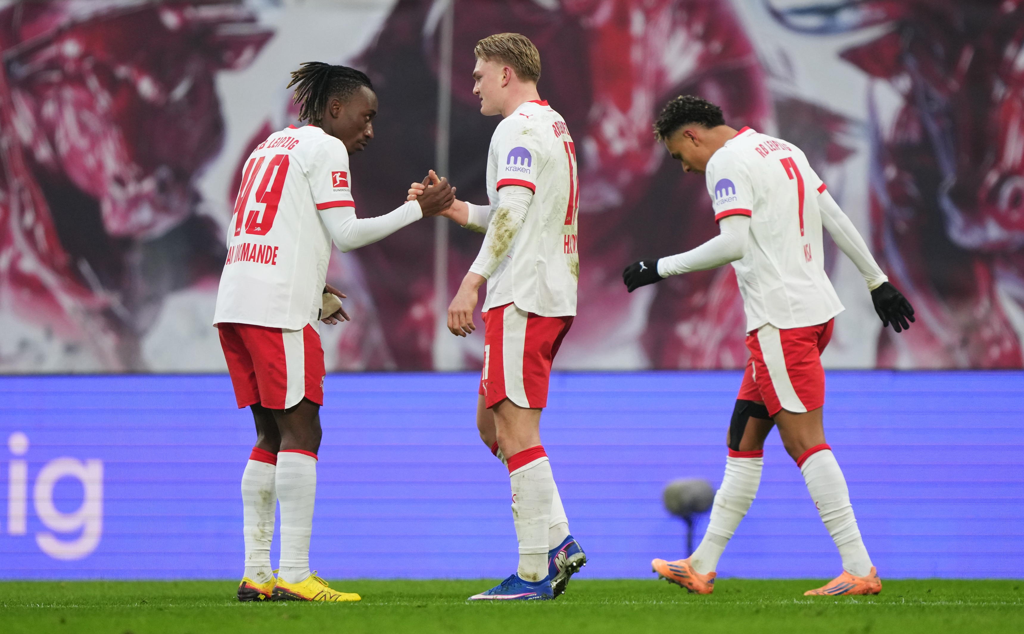 Yan Diomande shakes hands with Conrad Harder during RB Leipzig game.