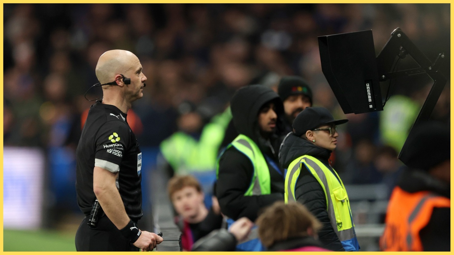 Anthony Taylor reviews a decision on the pitchside VAR monitor