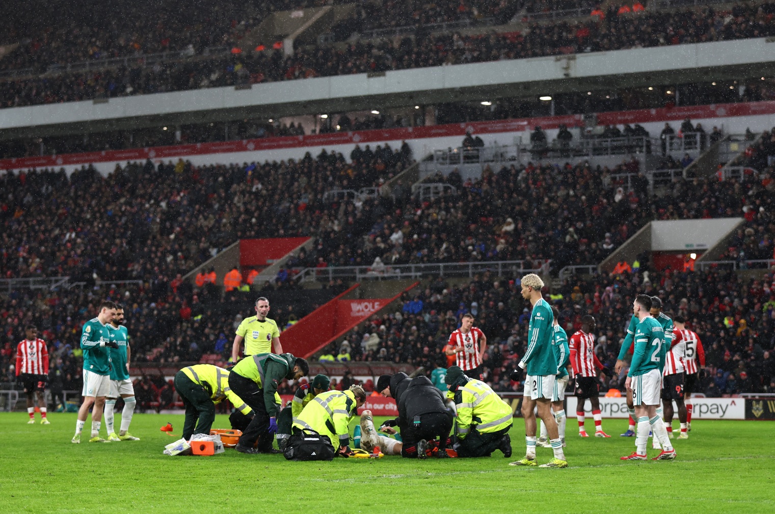 Wataru Endo receives treatment on the pitch after suffering a nasty injury in Liverpool's win over Sunderland