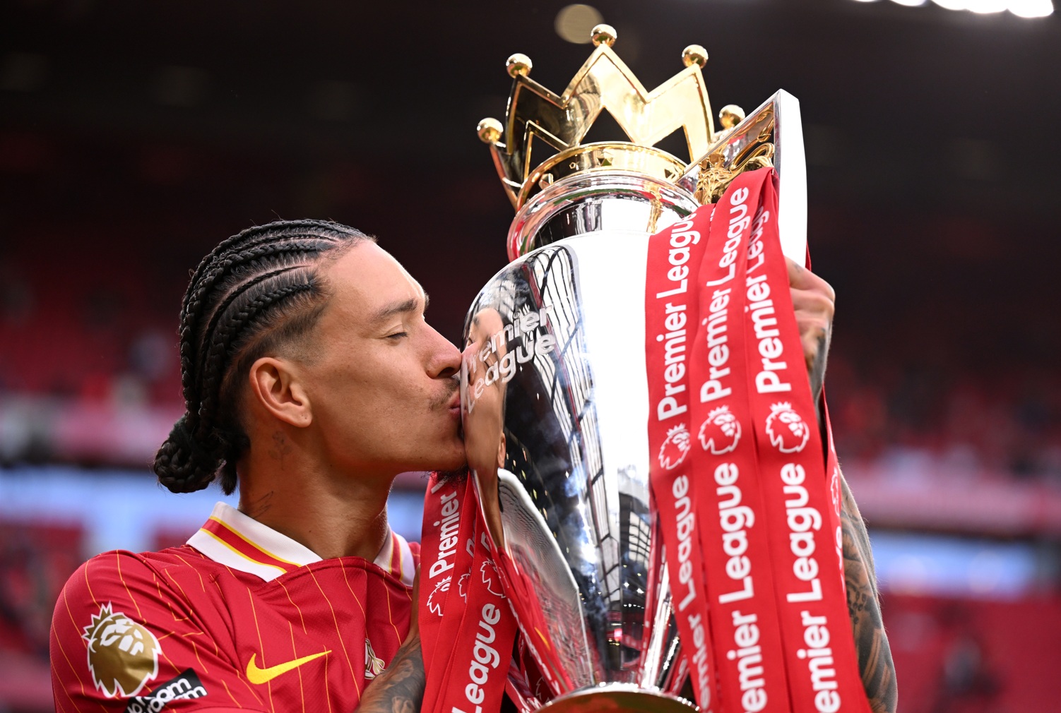 Darwin Nunez kisses the Premier League trophy that he won with Liverpool last season