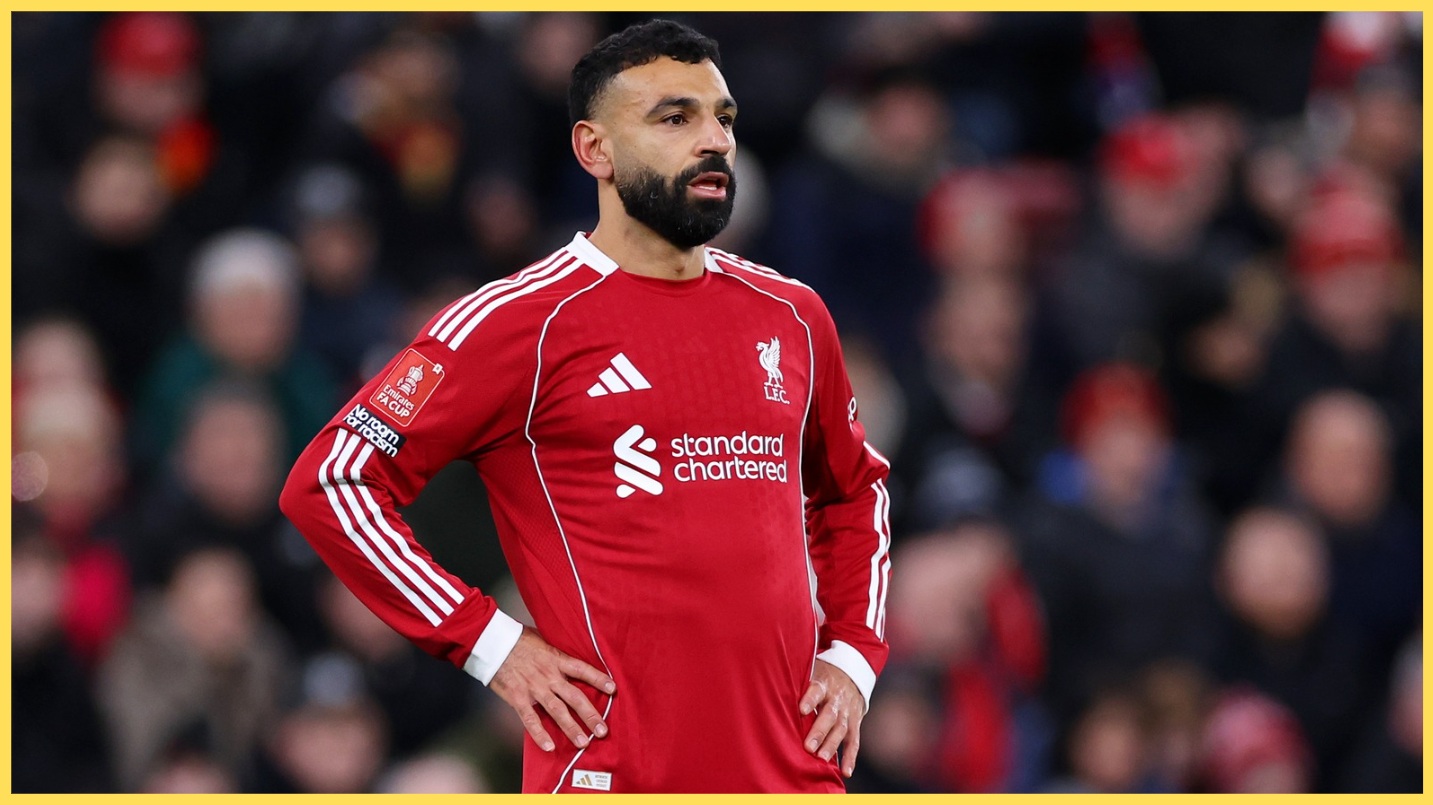 Mo Salah stands with his hands on his hips