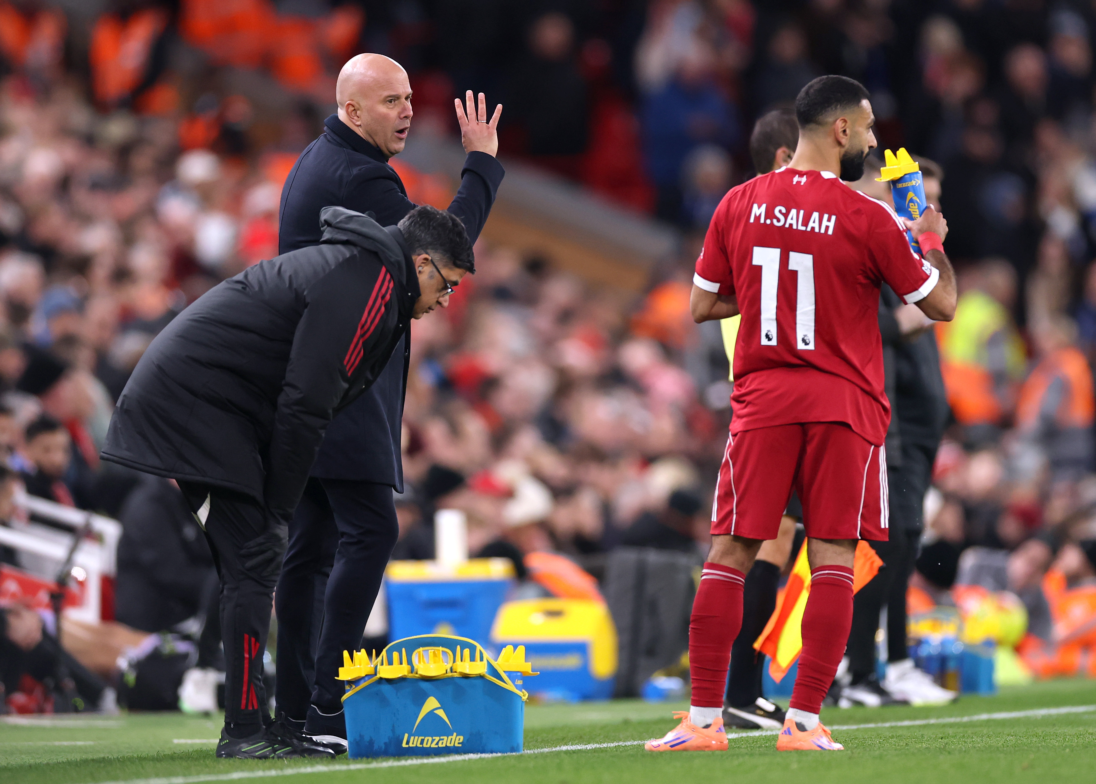 Arne Slot speaks to his players during a game at Anfield
