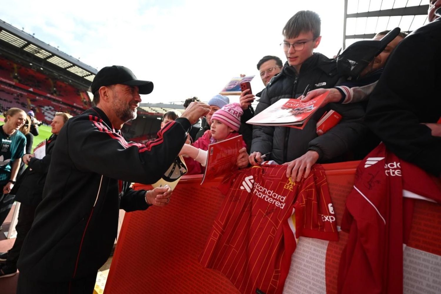 Jurgen Klopp signs Liverpool shirts at Anfield for Liverpool Legends game vs. Borussia Dortmund
