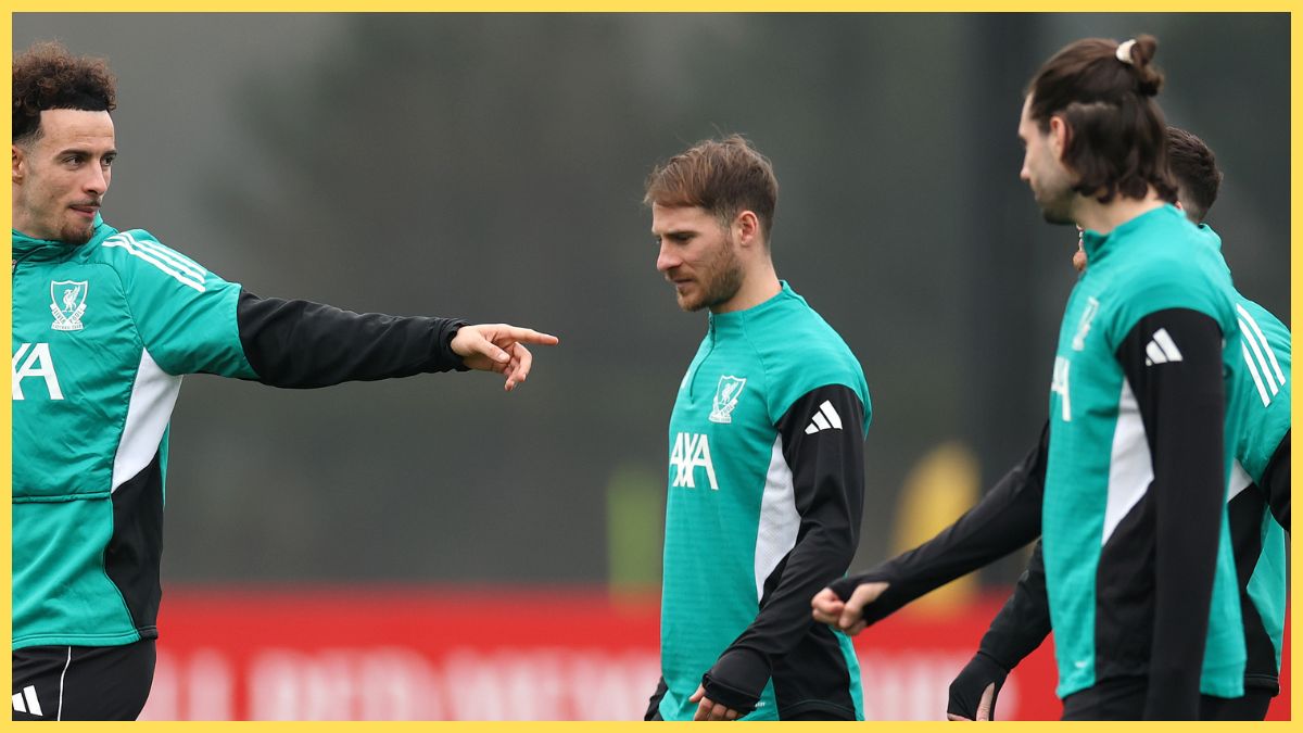 Curtis Jones points at Alexis Mac Allister during Liverpool team training.