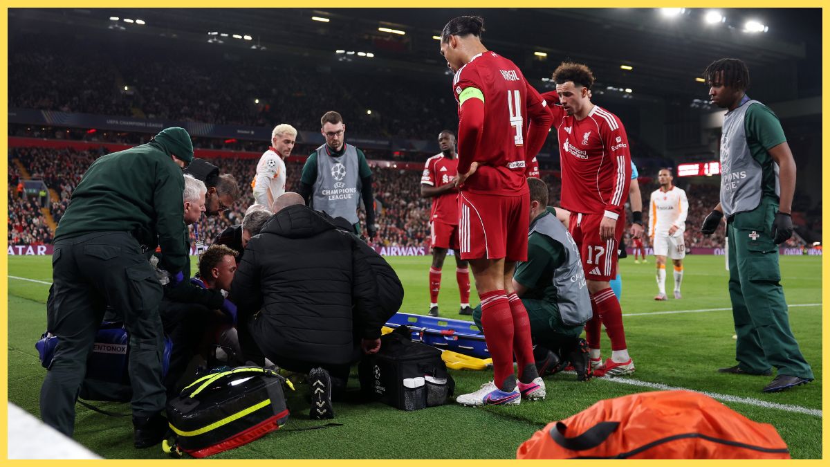 Virgil van Dijk and Curtis Jones of Liverpool look on as Noa Lang of Galatasaray A.S. is treated by medical staff after going down with an injury to his thumb