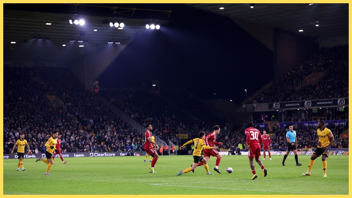 General view inside the stadium as Curtis Jones of Liverpool runs with the ball whilst under pressure from Hugo Bueno of Wolverhampton Wanderers