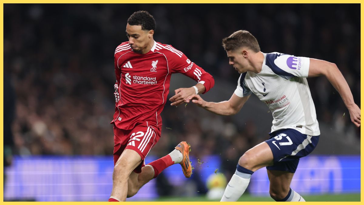 Hugo Ekitike of Liverpool runs with the ball whilst under pressure from Micky van de Ven of Tottenham