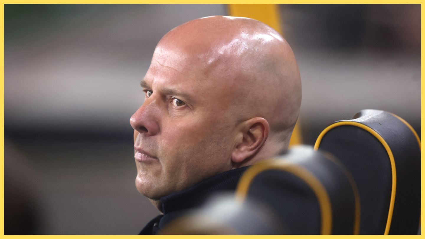 Arne Slot looks over his shoulder from the Wolves bench.