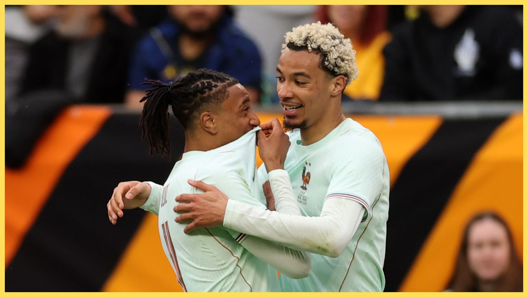Michael Olise hugs Hugo Ekitike during France game.