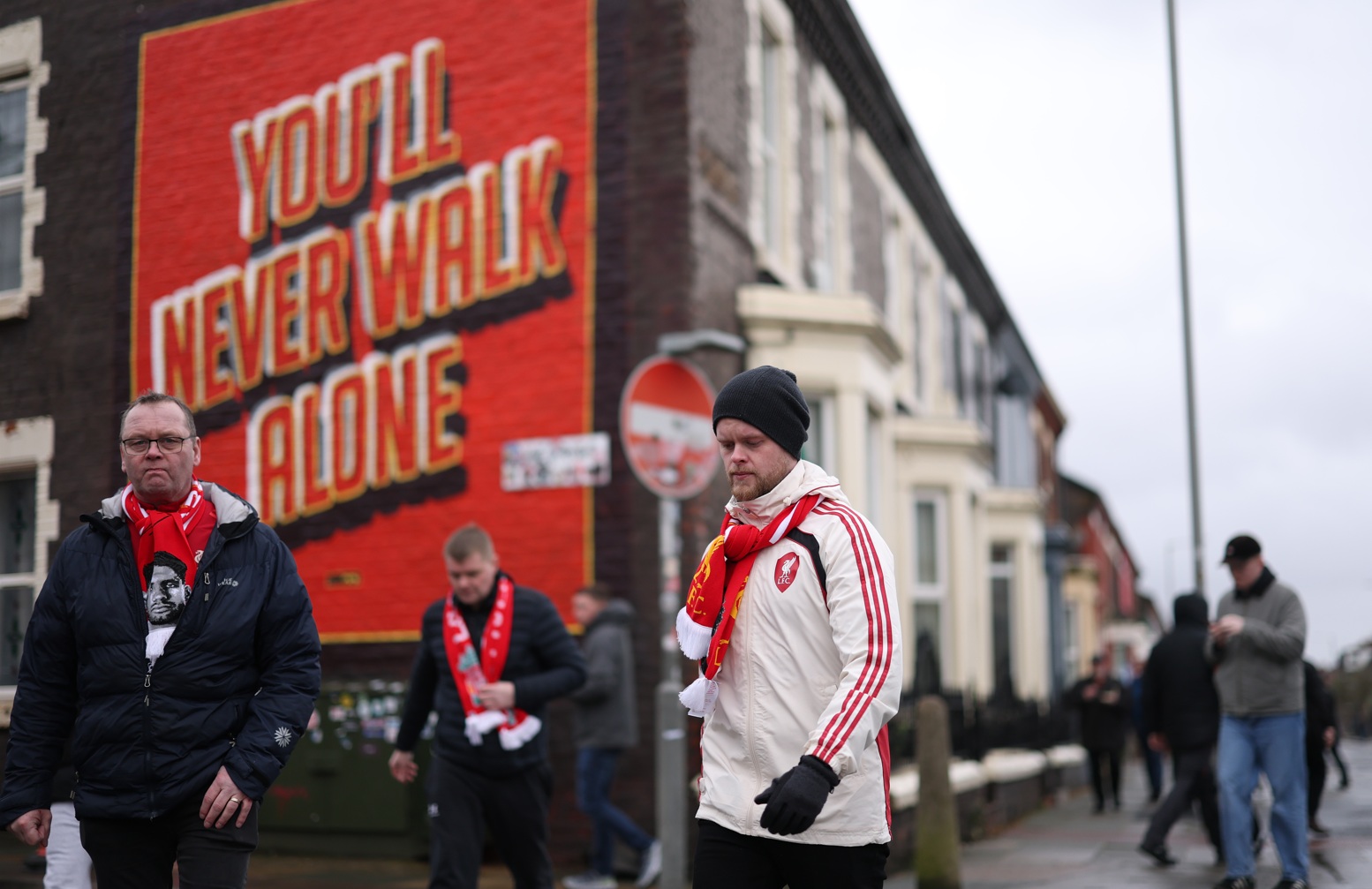 Liverpool supporters make their way towards Anfield on matchday