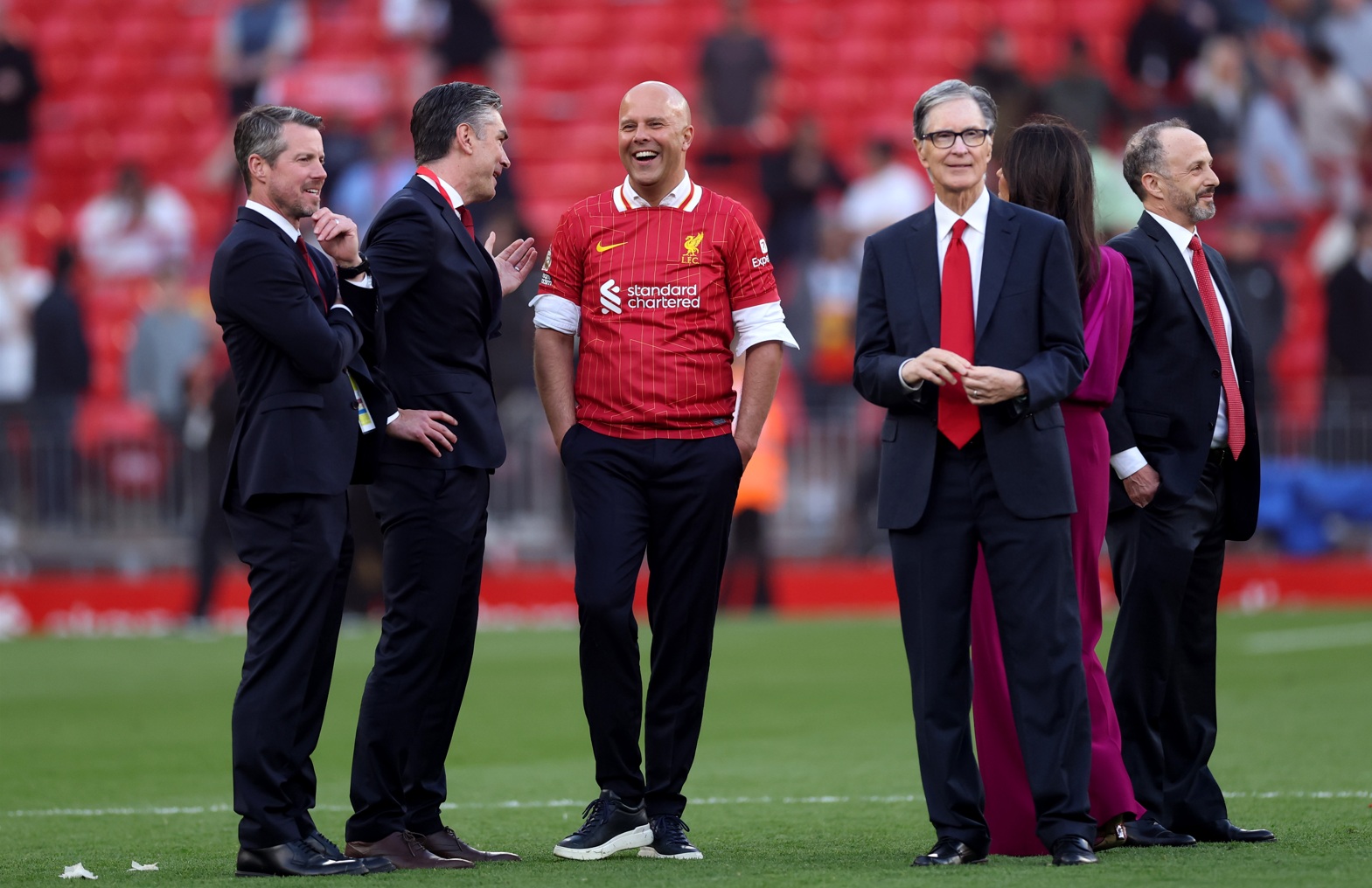 Richard Hughes speaks with Arne Slot after Liverpool clinched the Premier League title in 2025