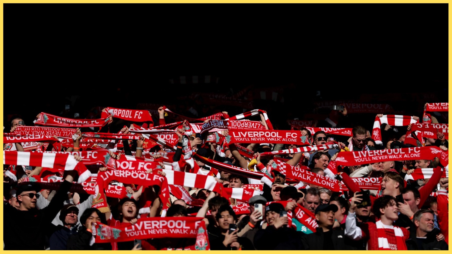 Liverpool fans hold their scarves aloft at Anfield