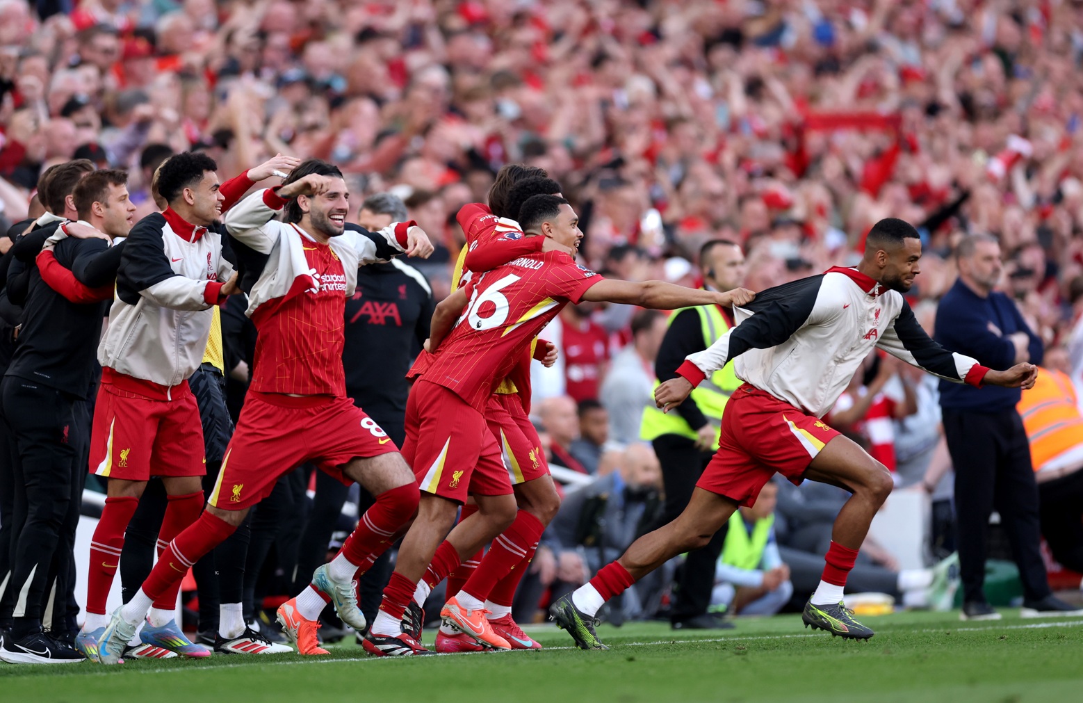 Liverpool players charge onto the pitch in celebration at the final whistle of the 5-1 win over Spurs which confirmed then as Premier League champions in 2025