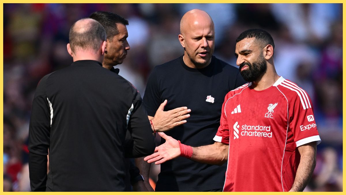 Mohamed Salah of Liverpool reacts with Arne Slot, Manager of Liverpool, after being substituted off during the Premier League match between Liverpool and Crystal Palace at Anfield